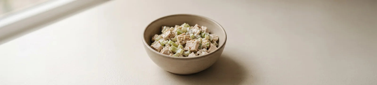 A bowl of chicken salad with diced celery